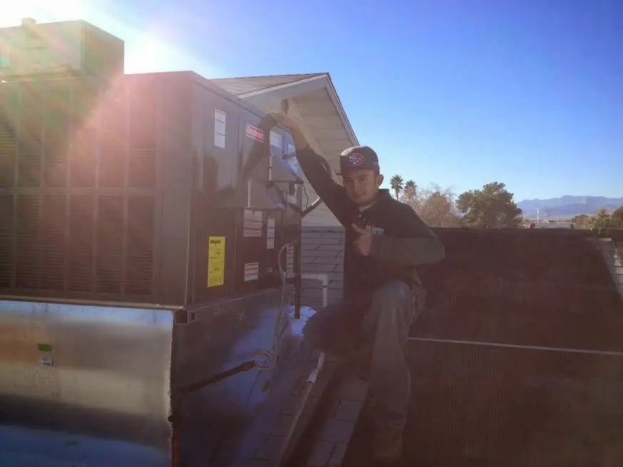 HVAC technician performing HVAC Inspection on a rooftop unit in Richmond